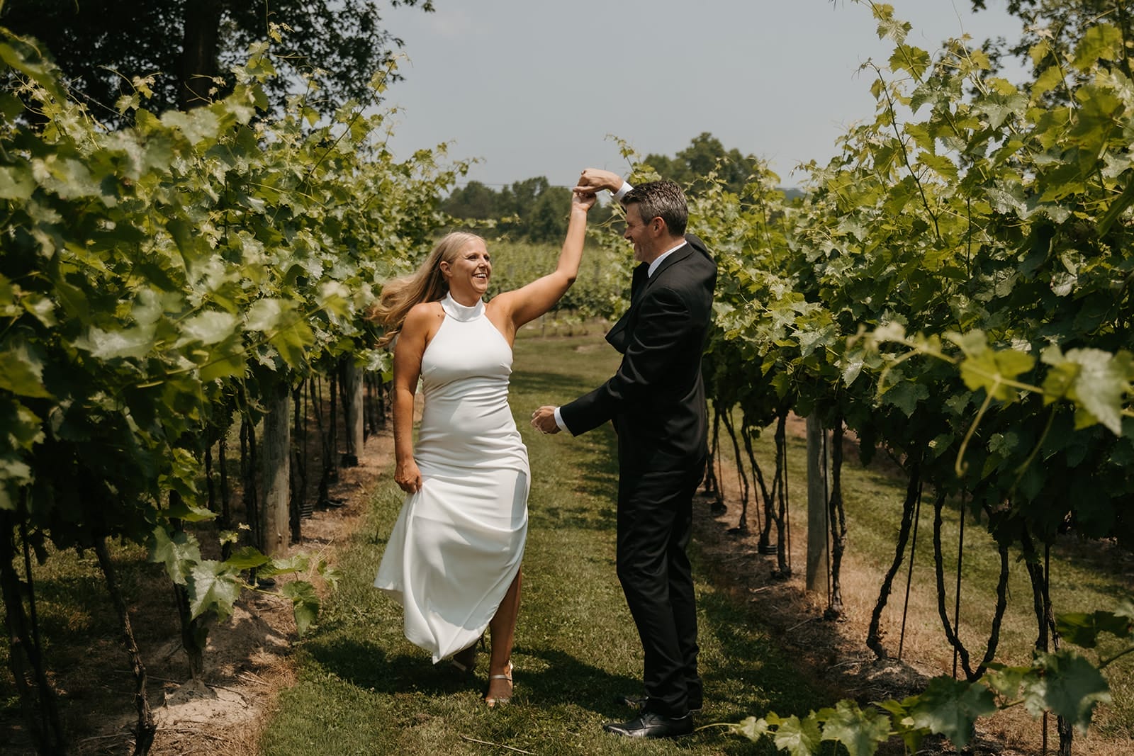 Elopement Couple Dancing through Vineyards
